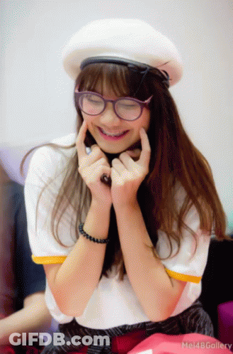 Girl In Glasses And White Hat Smiling Hands On Chin GIF