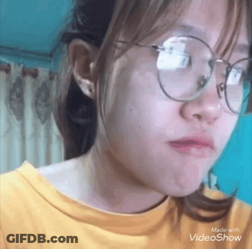 Girl In Glasses And Yellow Shirt Making A Face GIF