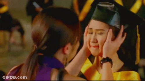 Girl In Graduation Cap And Gown Being Comforted GIF