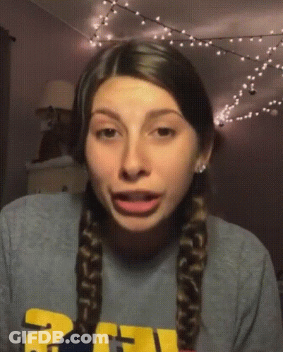 Girl In Gray Shirt With Yellow Letter U GIF