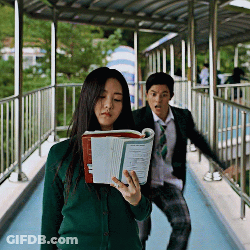 Girl In Green Cardigan Holding Book Saying Physics GIF