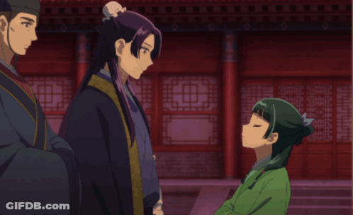 Girl In Green Dress Talking To Man In Black Robe GIF