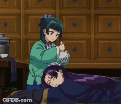 Girl In Green Jacket Holding Cup Another Girl Lays On Floor GIF