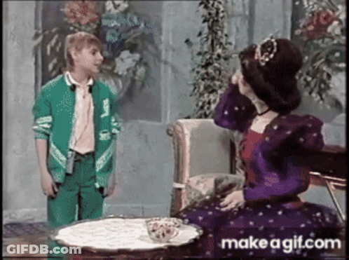 Girl In Green Jacket Next To Woman In Purple Dress GIF