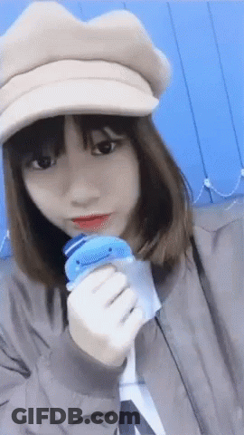 Girl In Hat Holding Blue Toy GIF
