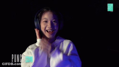 Girl In Headphones And White Hoodie Saying Punch Board GIF