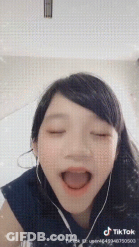 Girl In Headphones Making Funny Face GIF