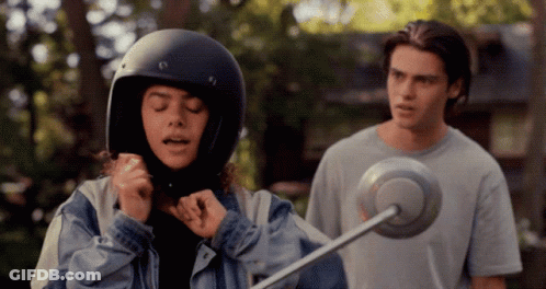 Girl In Helmet Standing Next To Man GIF