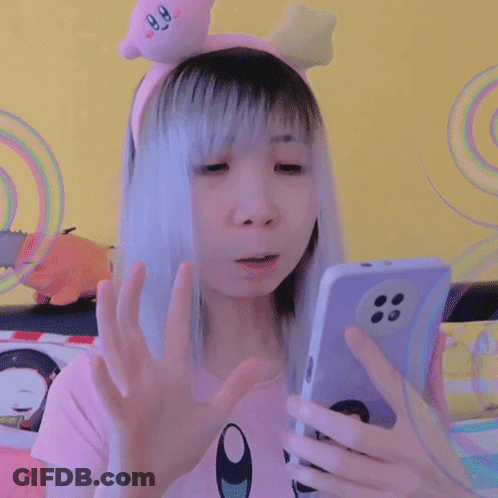 Girl In Kirby Headband Looking At Phone GIF