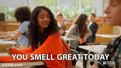 Girl In Orange Sweater Saying You Smell Great Today GIF