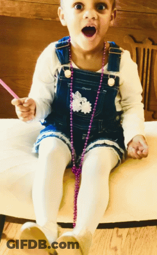 Girl In Overalls Sitting On Chair GIF