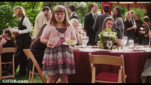 Girl In Pink Dress Holding Food GIF