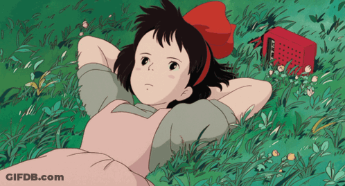 Girl In Pink Dress Laying In Grass GIF