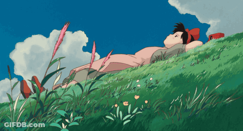 Girl In Pink Dress Laying On Grassy Hill GIF