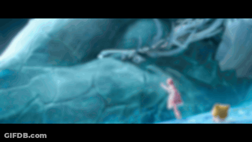 Girl In Pink Dress Standing Before Large Iceberg GIF