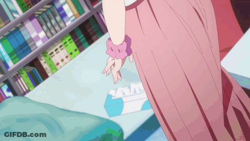 Girl In Pink Dress Standing In Front Of Bookshelf GIF