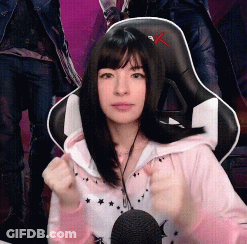Girl In Pink Hoodie Giving Thumbs Up At Microphone GIF
