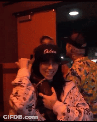 Girl In Pink Jacket Giving Middle Finger With I Love You GIF