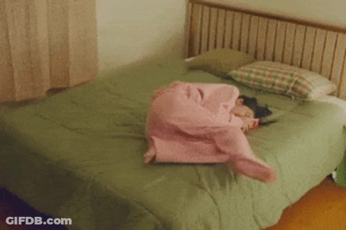 Girl In Pink Pajamas Lying On Bed GIF