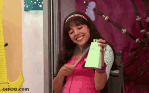 Girl In Pink Shirt Holding Green Bell GIF