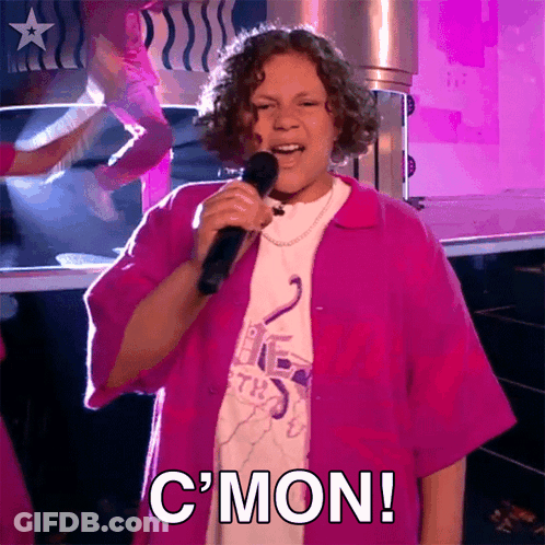 Girl In Pink Shirt Singing Into Microphone With C'mon GIF