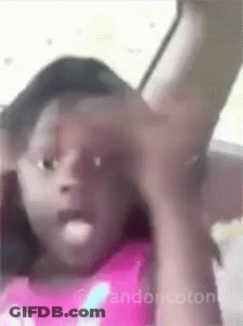 Girl In Pink Shirt Sitting In Car With Arm Outstretched GIF
