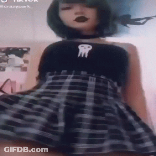Girl In Plaid Skirt And Black Skull Top GIF