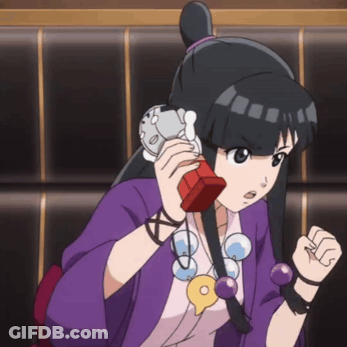 Girl In Purple Shirt Talking On Red Phone GIF