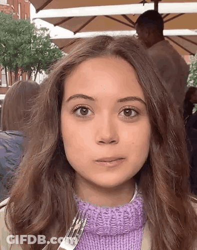 Girl In Purple Sweater Holding Fork GIF