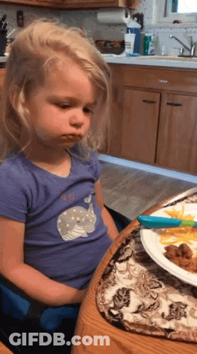 Girl In Purple Whale Shirt At Table GIF