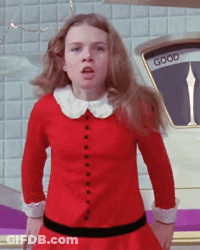 Girl In Red Dress Standing In Front Of Scale GIF