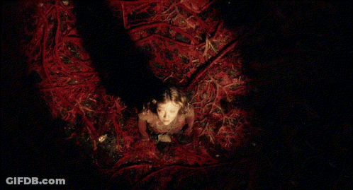 Girl In Red Dress Surrounded By Red Branches GIF