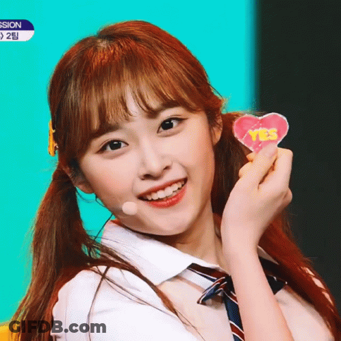 Girl In School Uniform Holding Yes Heart GIF