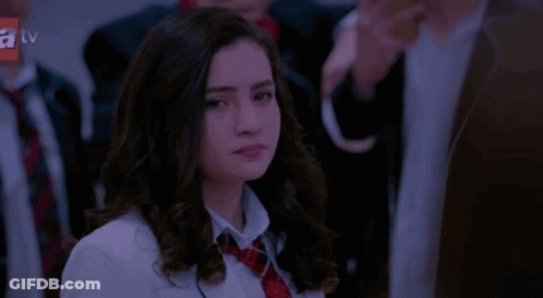 Girl In School Uniform Looking At Camera GIF