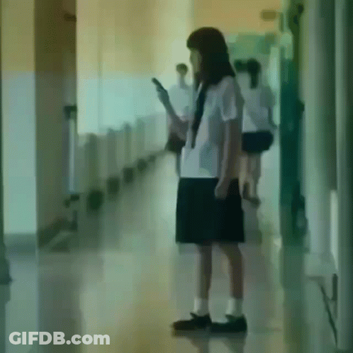 Girl In School Uniform Looking At Cell Phone GIF