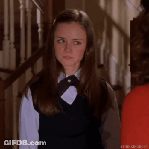 Girl In School Uniform Standing In Front Of Stairs GIF