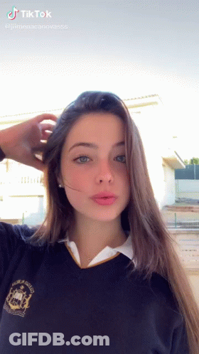 Girl In School Uniform Taking Selfie Hand In Hair GIF