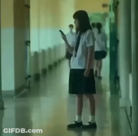 Girl In School Uniform Using Cell Phone GIF