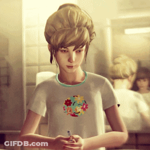Girl In Smiley Shirt Looking At Phone GIF