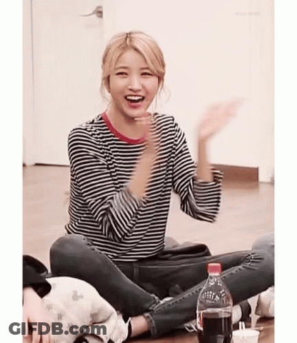 Girl In Striped Shirt Sitting Cross-Legged With Coke GIF