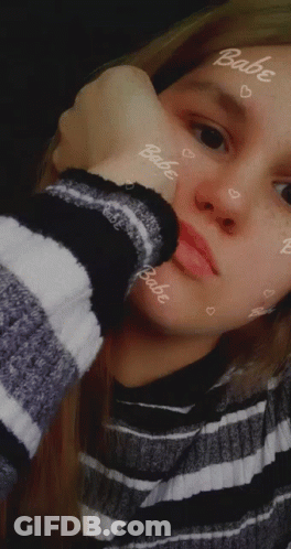 Girl In Striped Sweater With Babe On Face GIF