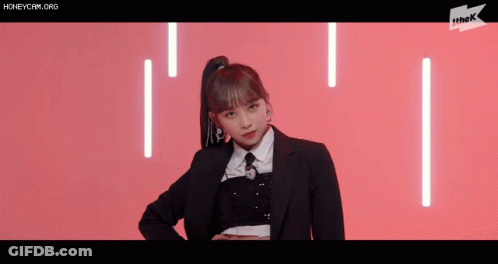 Girl In Suit And Tie On Pink Background GIF