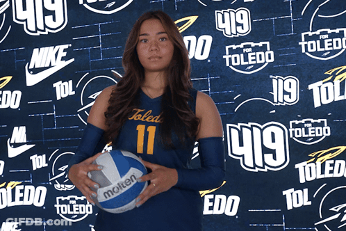 Girl In Toledo Uniform Holding Volleyball GIF