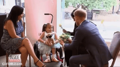 Girl In Wheelchair Receiving Flowers GIF
