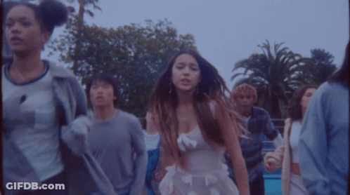 Girl In White Dress Dancing With Group GIF