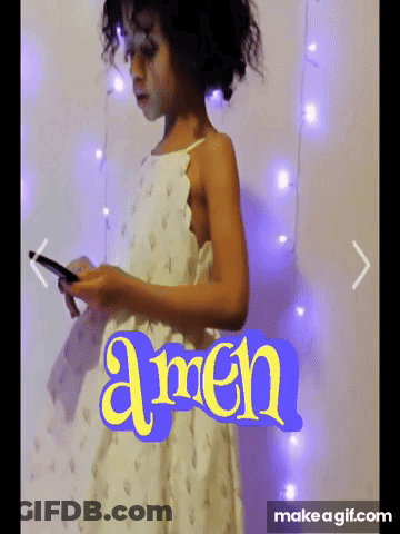 Girl In White Dress Holding Phone In Front Of Amen Wall GIF