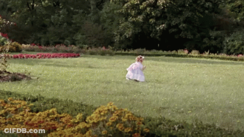Girl In White Dress Runs In Grassy Field GIF