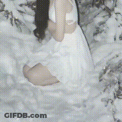Girl In White Dress Sitting In Snow GIF