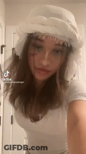 Girl In White Hat With Cross On Neck GIF