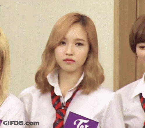 Girl In White Shirt And Tie Holding Tor Book GIF